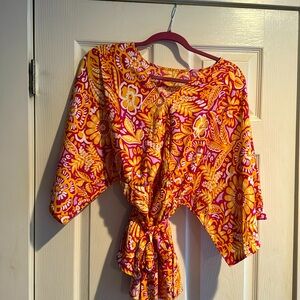 Adorable women’s medium blouse with a wrap tie waist. Very figure flattering.